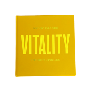 Book titled 'Vitality' with bright yellow text on a gold background