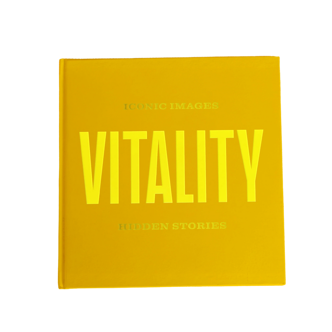 Book titled 'Vitality' with bright yellow text on a gold background